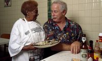 New Orleans writer and television personality Ronnie Virgets is served the house specialty, ice-cold oysters on the half shell, by Alma Griffin at Casamento's Seafood Restaurant in Uptown New Orleans.