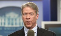 FILE - In this Feb. 26, 2010 file photo, Major Garrett speaks from the White House Press Briefing Room in Washington. Garrett is writing a book about covering Donald Trump called, “Mr. Trump’s Wild Ride” which will be released next fall. (AP Photo/Charles Dharapak, File)